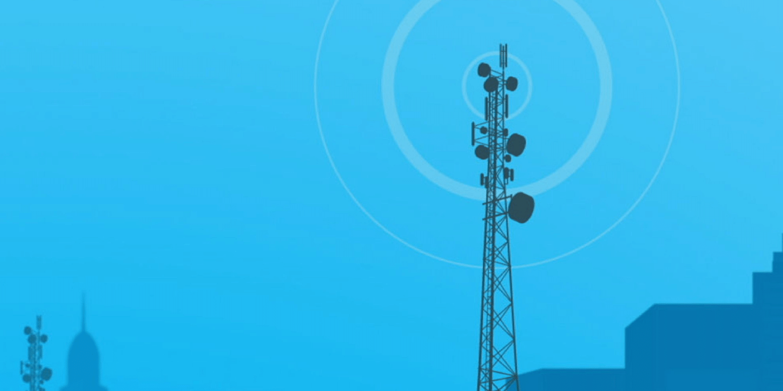 A graphic of a cell phone tower broadcasting its signal over an urban landscape