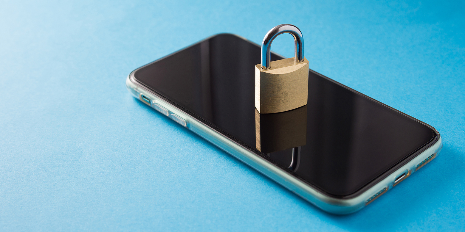 GSM unlocked - A smartphone with a physical padlock sitting on the screen