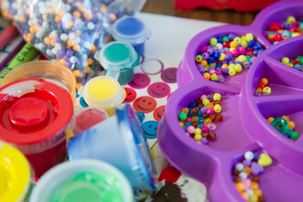 An assortment of various arts and crafts items, such as paint and beads. 